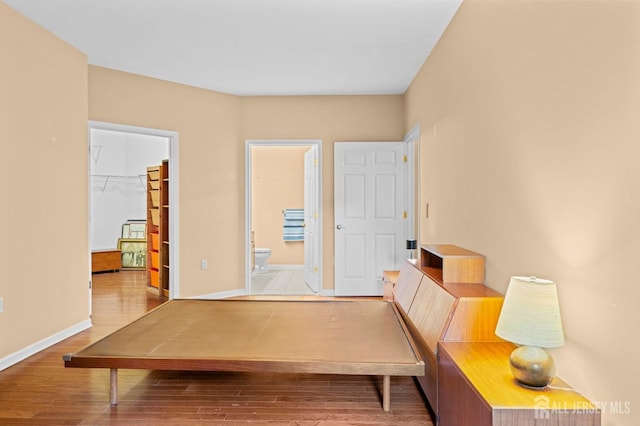 540 Cranbury Rd Unit 107, East Brunswick, NJ 08816 - bedroom with a spacious closet, wood finished floors, baseboards, connected bathroom, and a closet