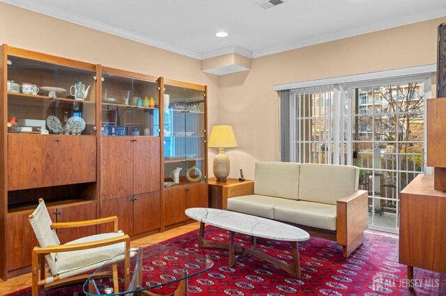 living area with crown molding