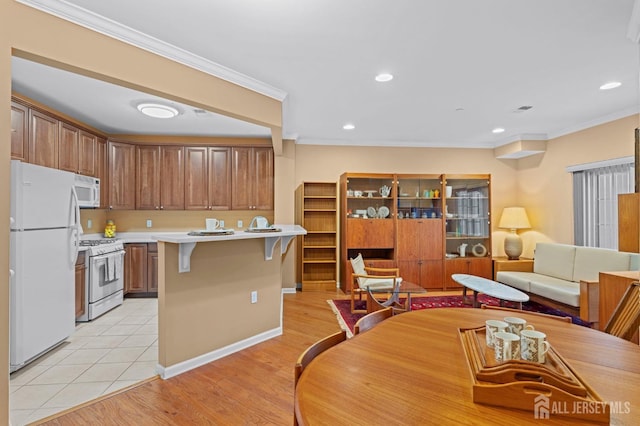 540 Cranbury Rd Unit 107, East Brunswick, NJ 08816 - kitchen with white appliances, a kitchen breakfast bar, light countertops, crown molding, and open floor plan