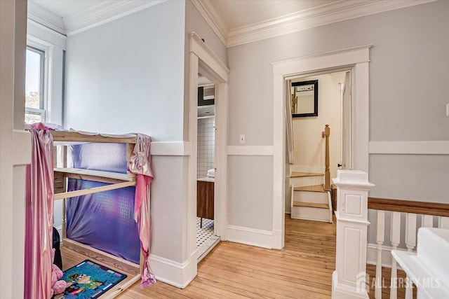 corridor featuring light hardwood / wood-style floors and ornamental molding