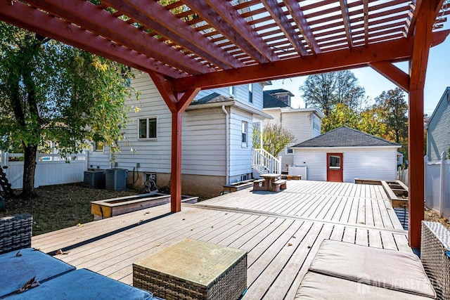 wooden deck with a pergola, an outdoor structure, and central AC unit