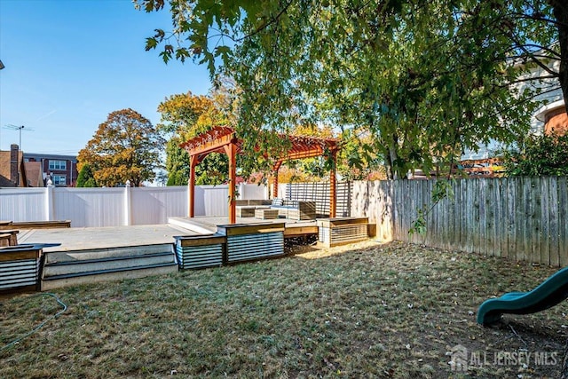 view of yard featuring a pergola and a wooden deck