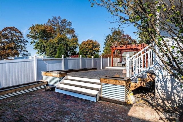 wooden terrace featuring a pergola and a patio area