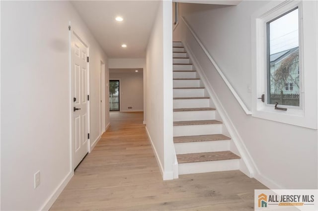 stairs with hardwood / wood-style floors