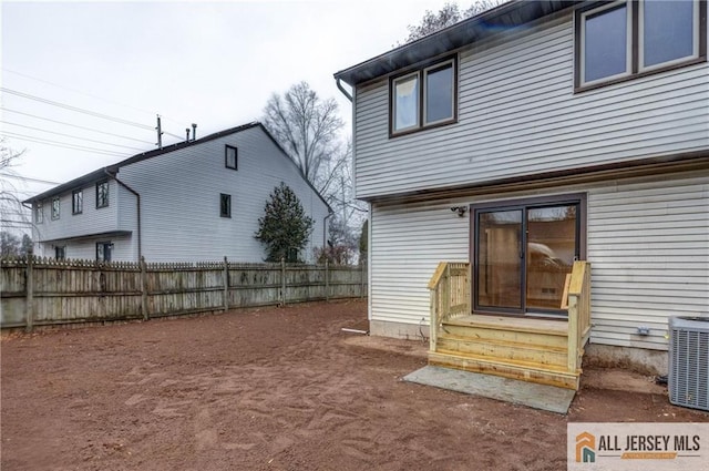 rear view of house featuring cooling unit