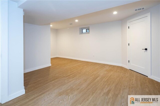 basement with hardwood / wood-style floors