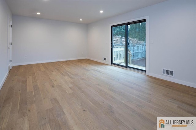 spare room featuring light wood-type flooring