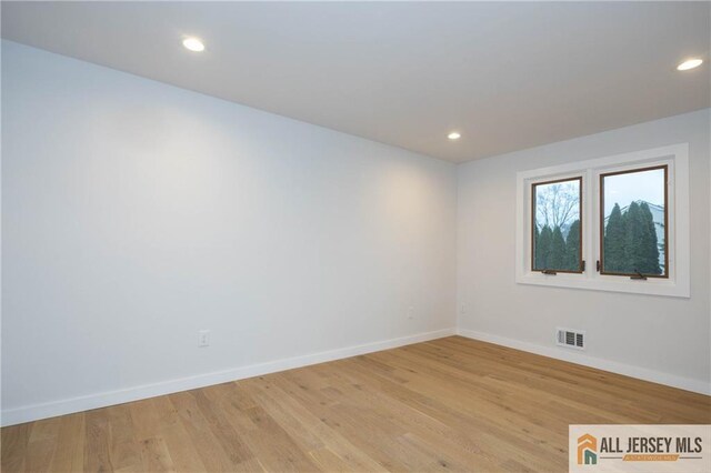 spare room with light hardwood / wood-style floors