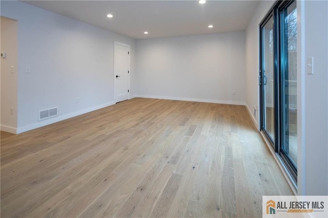 spare room with light hardwood / wood-style flooring