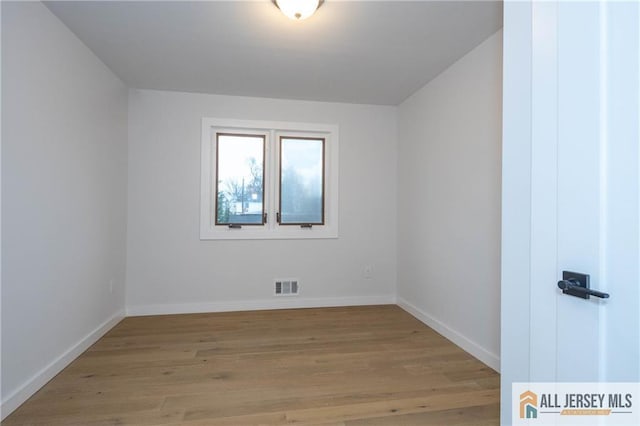 unfurnished room with light wood-type flooring