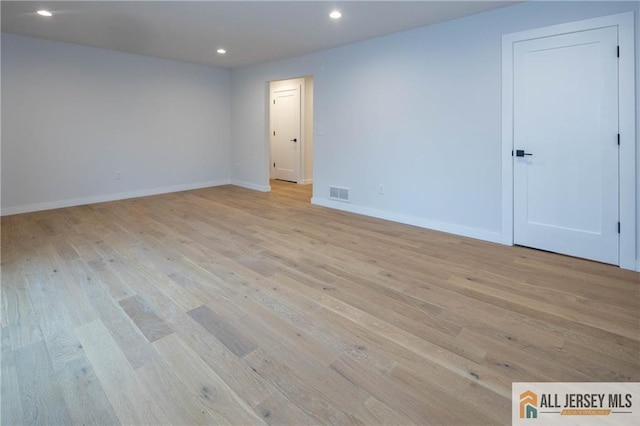 unfurnished room with light hardwood / wood-style flooring