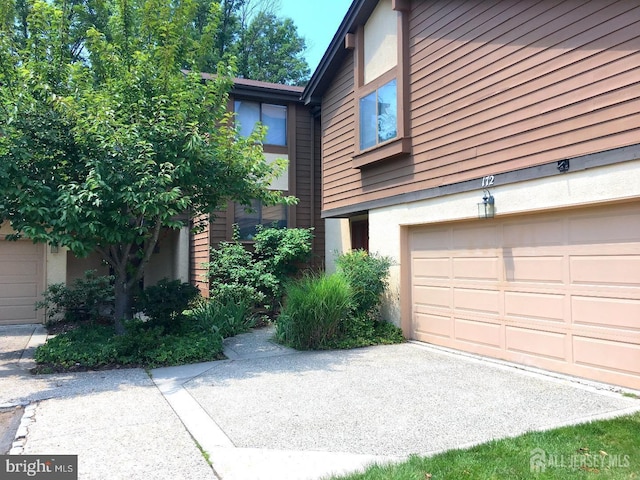 172 Sayre Dr, Plainsboro, NJ 08540 - view of side of property with stucco siding and a garage