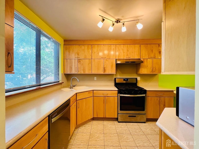 172 Sayre Dr, Plainsboro, NJ 08540 - kitchen with appliances with stainless steel finishes, under cabinet range hood, a sink, light countertops, and light tile patterned floors