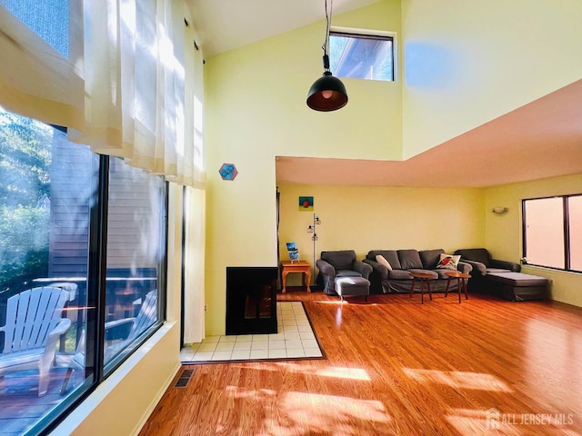 172 Sayre Dr, Plainsboro, NJ 08540 - living room with high vaulted ceiling, wood finished floors, and a fireplace