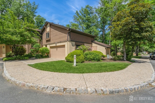 172 Sayre Dr, Plainsboro, NJ 08540 - view of home's exterior with concrete driveway, stucco siding, an attached garage, and a lawn