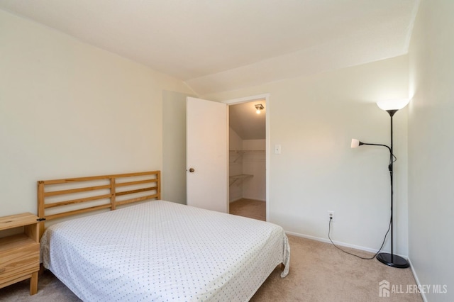 172 Sayre Dr, Plainsboro, NJ 08540 - carpeted bedroom featuring lofted ceiling, a walk in closet, and baseboards