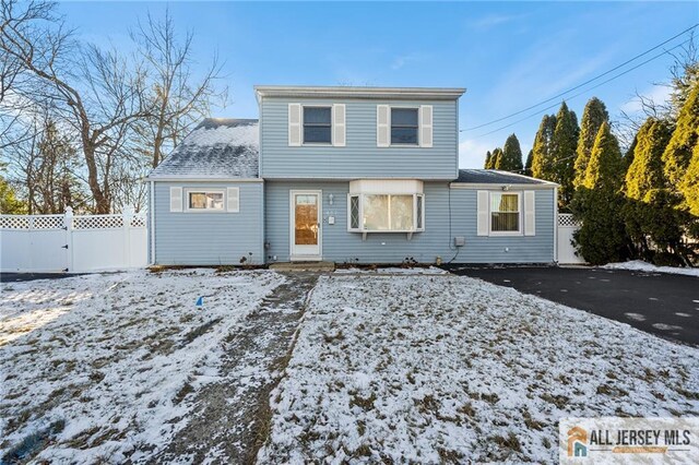 view of snow covered rear of property