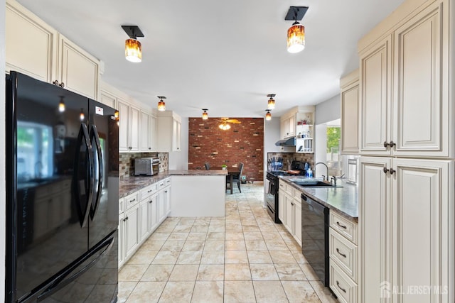 15 Creighton Cir, Old Bridge, NJ 08857 - kitchen featuring black appliances, cream cabinetry, tasteful backsplash, a peninsula, and brick wall