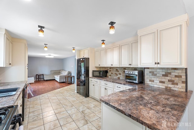 15 Creighton Cir, Old Bridge, NJ 08857 - kitchen featuring black appliances, open floor plan, cream cabinets, decorative backsplash, and light tile patterned floors