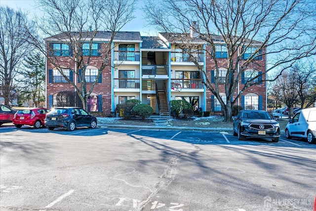 view of building exterior featuring uncovered parking