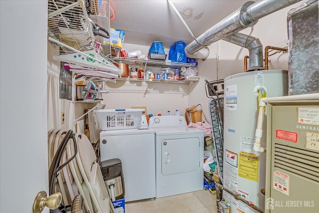 clothes washing area featuring laundry area, water heater, independent washer and dryer, and tile patterned floors