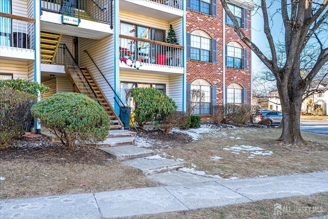 exterior space with stairs and brick siding