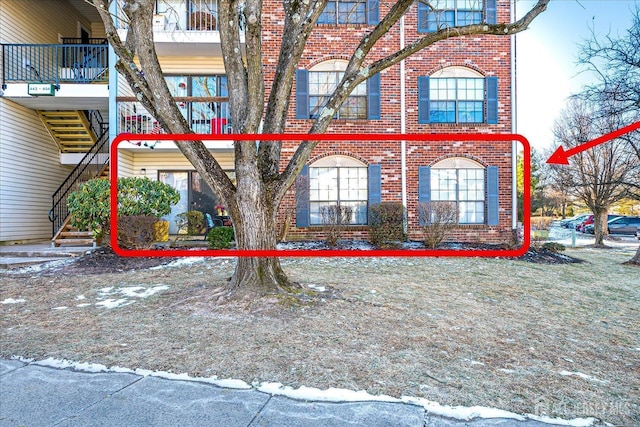 view of home's exterior with brick siding and stairway