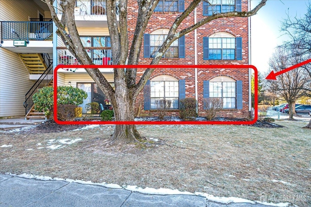 446 Danbury Ln, East Brunswick, NJ 08816 - view of property exterior featuring brick siding, a balcony, and stairs