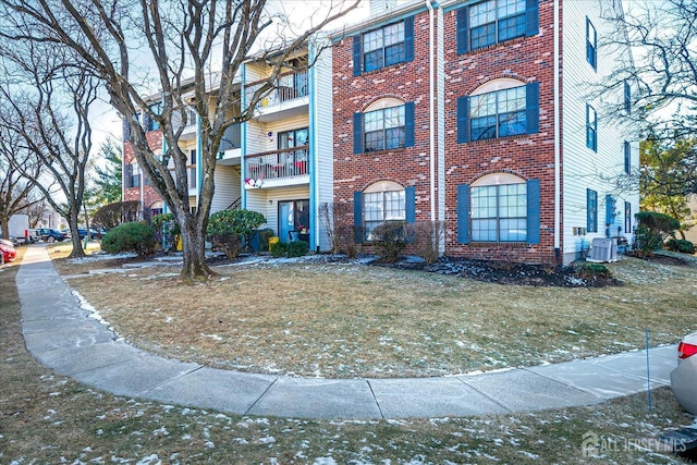 446 Danbury Ln, East Brunswick, NJ 08816 - view of front of house with central AC unit, brick siding, and a balcony