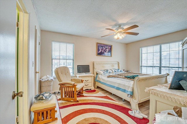 446 Danbury Ln, East Brunswick, NJ 08816 - bedroom with a textured ceiling, light wood finished floors, and ceiling fan