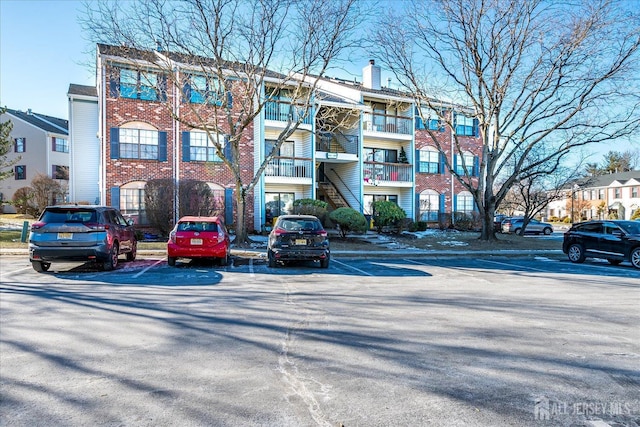 view of property with uncovered parking