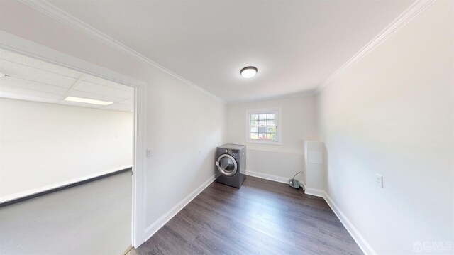 clothes washing area featuring washer / clothes dryer, dark hardwood / wood-style floors, and crown molding