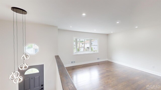 unfurnished living room with dark hardwood / wood-style floors