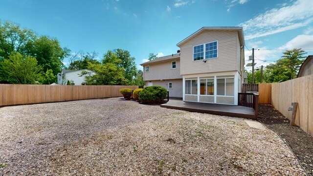 rear view of property featuring a sunroom and a patio