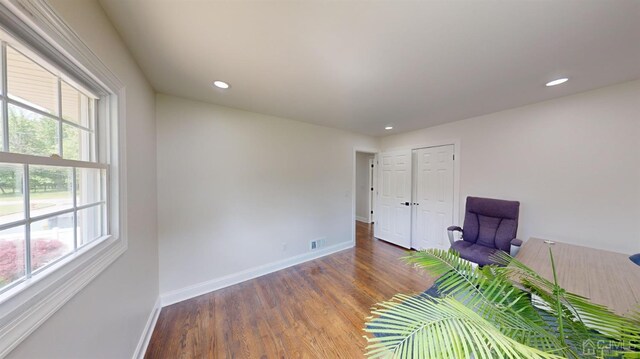 unfurnished room with dark hardwood / wood-style flooring