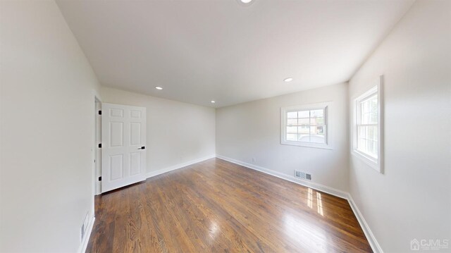 spare room with dark hardwood / wood-style flooring