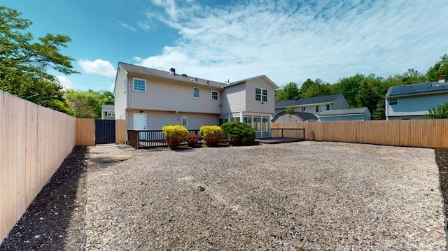 back of house featuring a fenced backyard