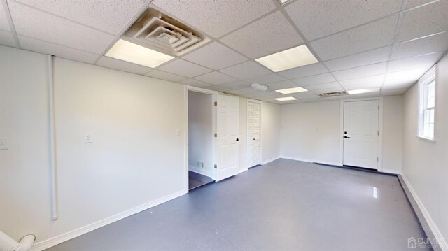 basement featuring a drop ceiling