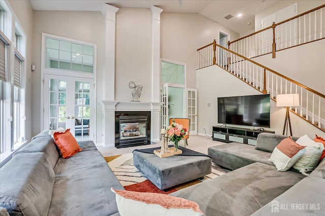 37 Equestrian Way, Monroe, NJ 08831 - living room featuring high vaulted ceiling, stairs, a fireplace with flush hearth, carpet floors, and french doors