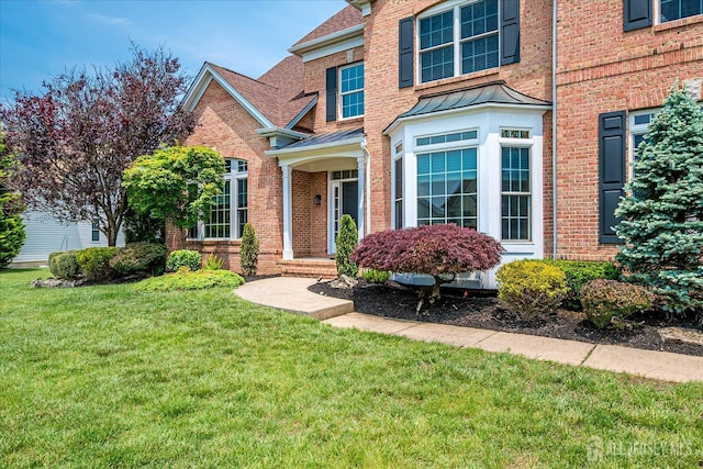 37 Equestrian Way, Monroe, NJ 08831 - traditional-style house featuring a front lawn, a standing seam roof, brick siding, and roof with shingles