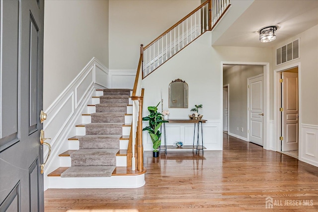 37 Equestrian Way, Monroe, NJ 08831 - foyer entrance featuring a decorative wall, wood finished floors, stairs, and wainscoting