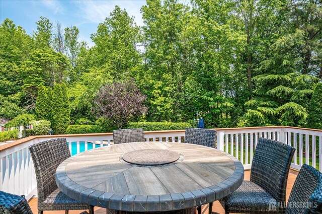 37 Equestrian Way, Monroe, NJ 08831 - wooden deck with outdoor dining space, view of wooded area, and a swimming pool