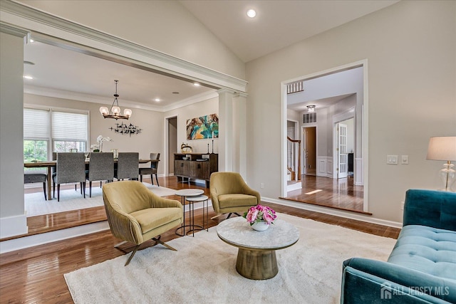37 Equestrian Way, Monroe, NJ 08831 - sitting room with wood finished floors, a chandelier, crown molding, stairs, and lofted ceiling