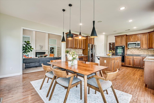 37 Equestrian Way, Monroe, NJ 08831 - dining room featuring light wood-type flooring, baseboards, recessed lighting, and a glass covered fireplace