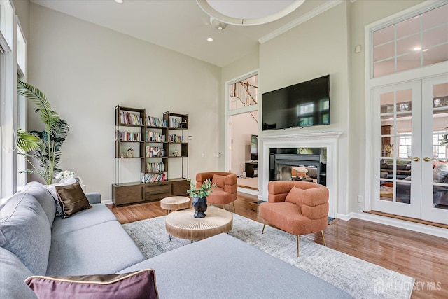 37 Equestrian Way, Monroe, NJ 08831 - living area featuring french doors, wood finished floors, baseboards, recessed lighting, and a glass covered fireplace