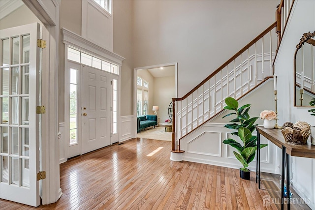 37 Equestrian Way, Monroe, NJ 08831 - foyer with a decorative wall, stairway, healthy amount of natural light, light wood-style flooring, and a wainscoted wall