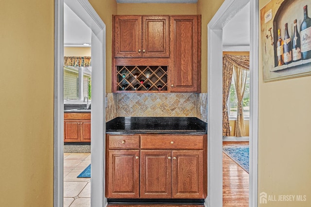9 Narrow Brook Ct, Plainsboro, NJ 08536 - kitchen with decorative backsplash, dark countertops, healthy amount of natural light, and brown cabinetry