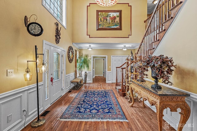 9 Narrow Brook Ct, Plainsboro, NJ 08536 - foyer featuring stairs, a high ceiling, a wainscoted wall, a decorative wall, and wood finished floors