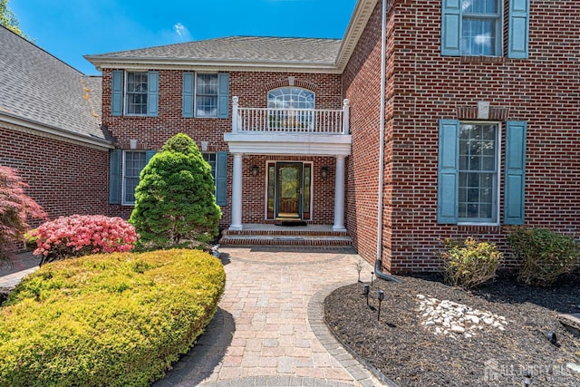9 Narrow Brook Ct, Plainsboro, NJ 08536 - property entrance featuring brick siding, a balcony, and roof with shingles