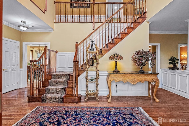 9 Narrow Brook Ct, Plainsboro, NJ 08536 - staircase featuring wood finished floors, crown molding, a chandelier, and a high ceiling